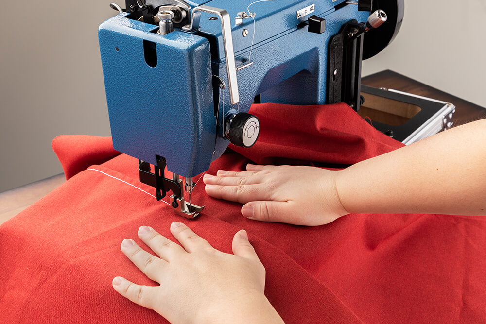 Placing your hands on both sides of the seam helps you control your stitching.